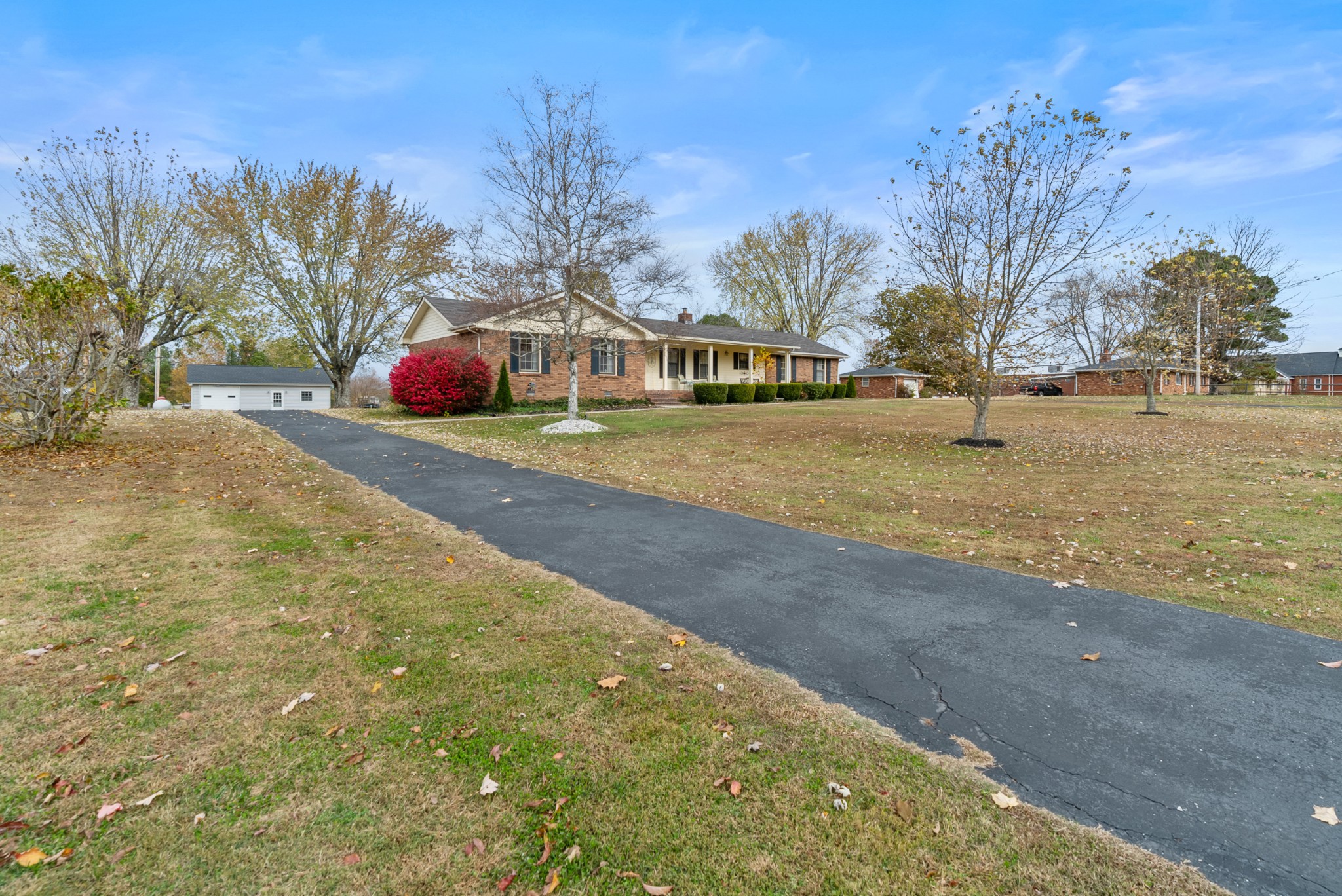 6980 Bethel Road Greenbrier, TN 37073 - Photo 2 of 51 a yellow house with trees in front of it