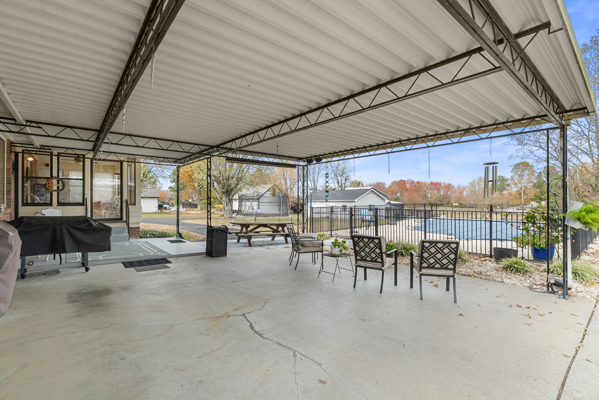 6980 Bethel Road Greenbrier, TN 37073 - Photo 42 of 51 a view of a patio with table and chairs potted plants with wooden floor