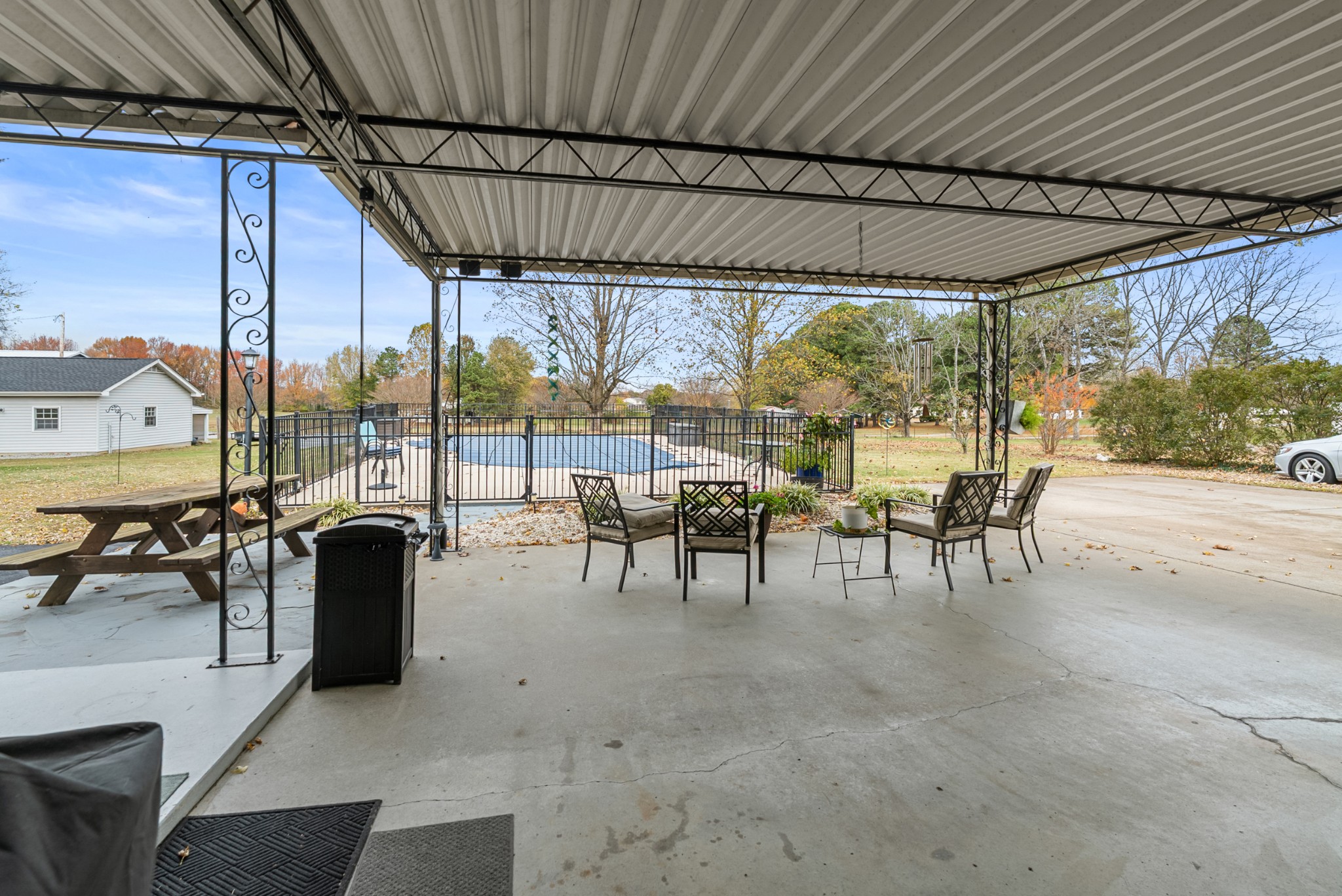 6980 Bethel Road Greenbrier, TN 37073 - Photo 43 of 51 a view of a patio with table and chairs potted plants with wooden floor