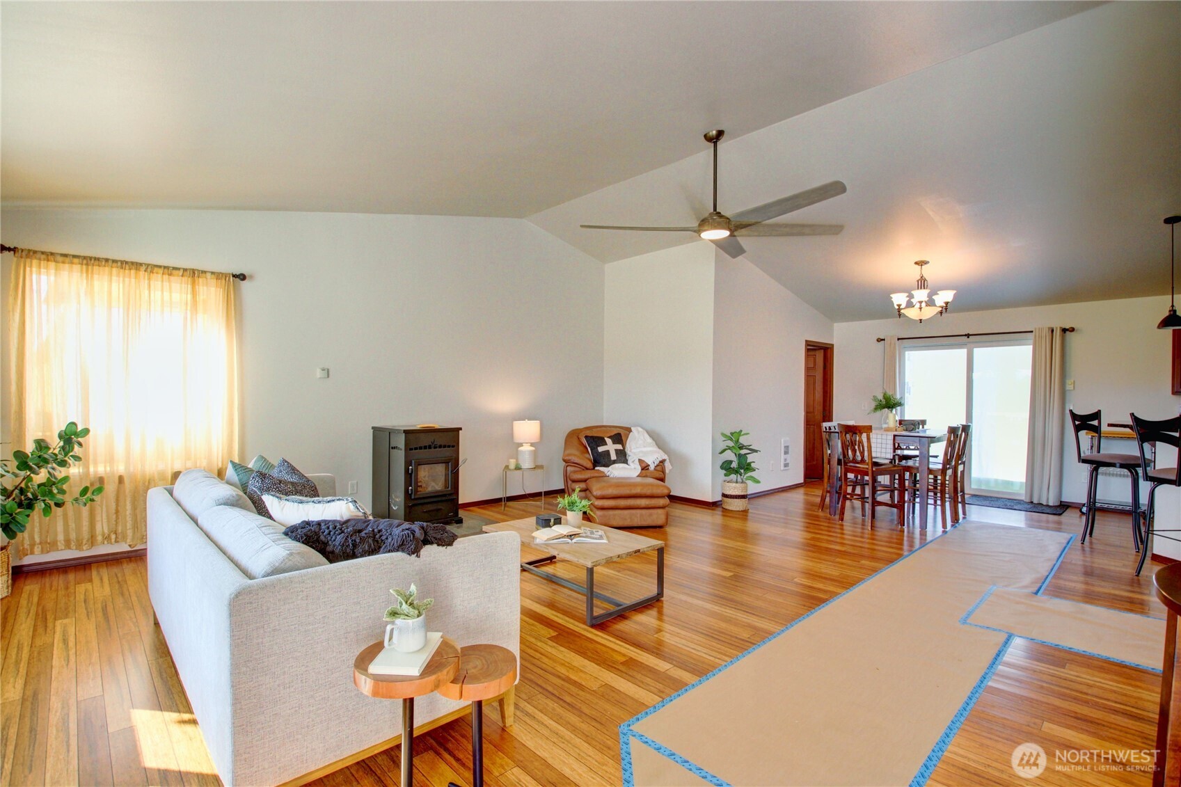8336 Pinelli Road Sedro-Woolley, WA 98284 - Photo 2 of 15 a living room with furniture a dining table and a fireplace