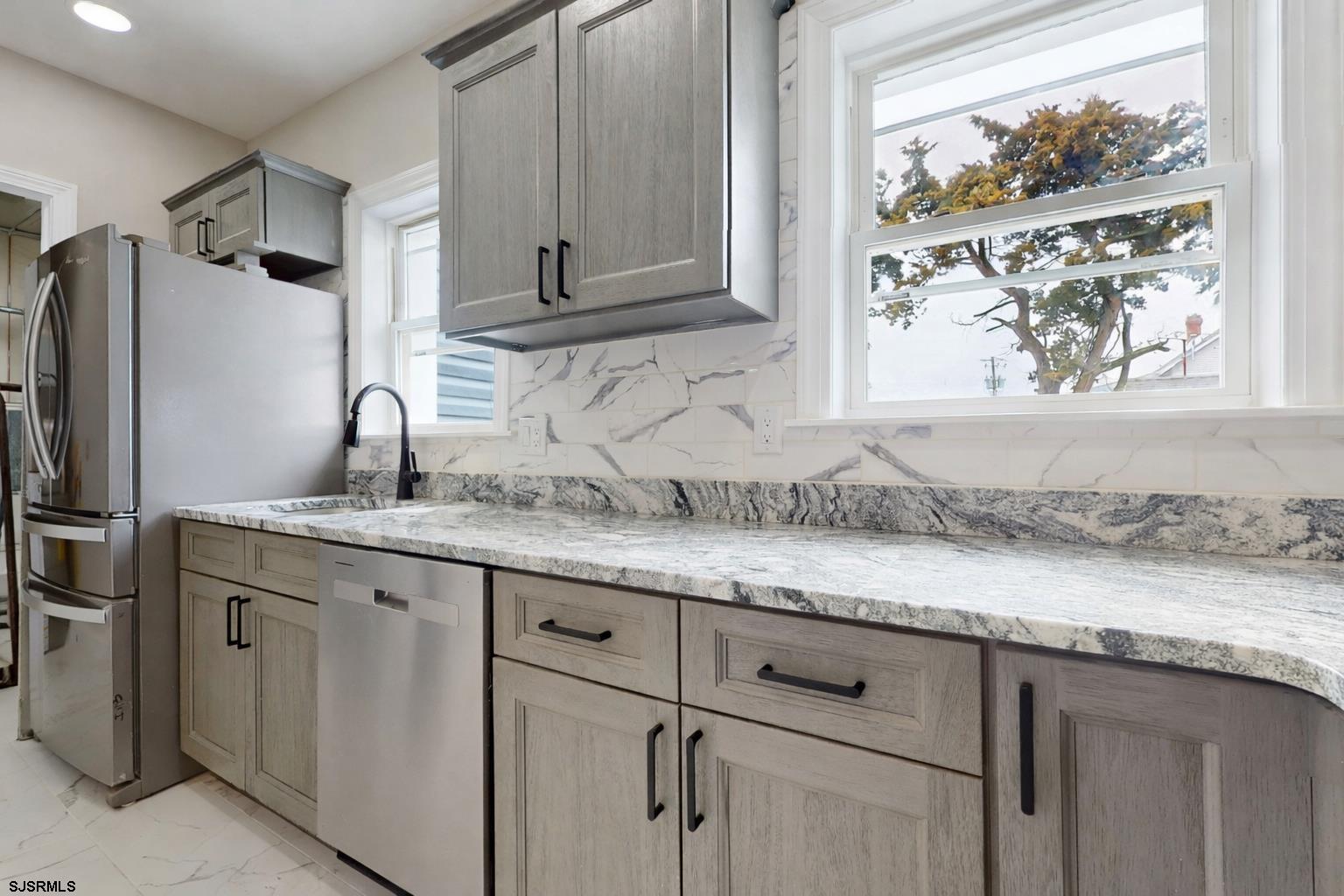 108 East 17th Avenue North Wildwood, NJ 08260 - Photo 6 of 51 a kitchen with granite countertop stainless steel appliances white cabinets and a sink