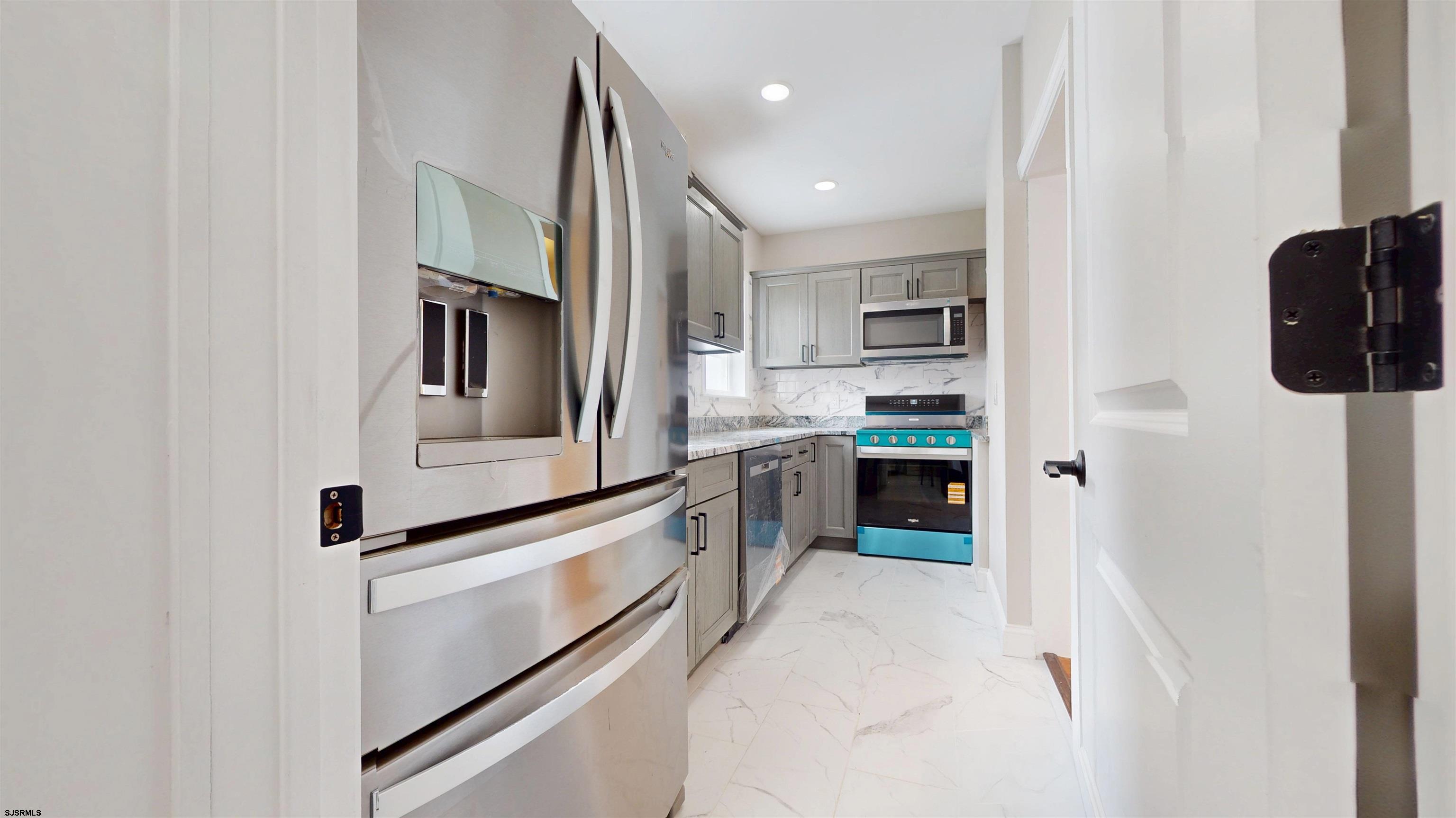 108 East 17th Avenue North Wildwood, NJ 08260 - Photo 7 of 51 a kitchen with stainless steel appliances granite countertop a refrigerator and a sink