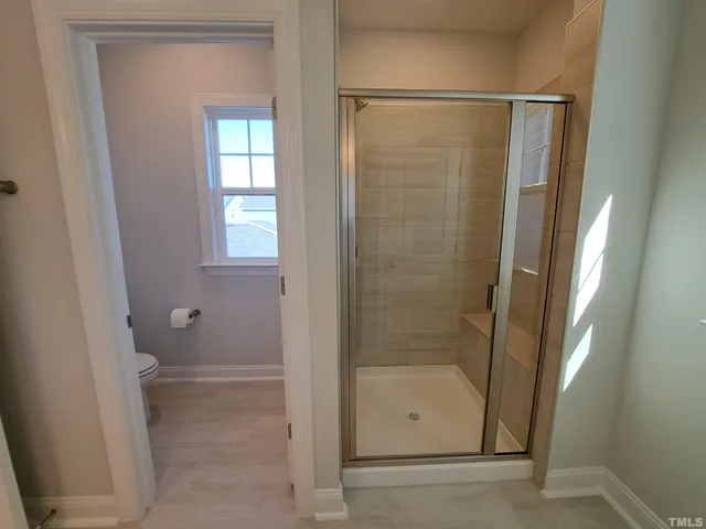 a bathroom with a glass shower door