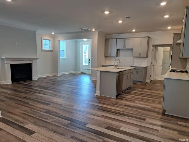 a large kitchen with stainless steel appliances granite countertop a stove and a refrigerator