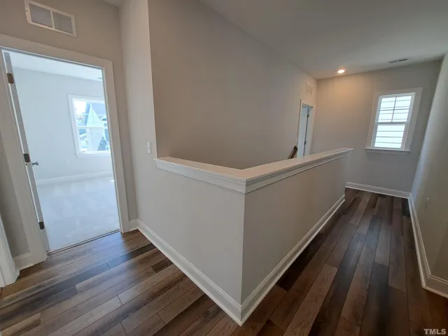 a view of hallway with wooden floor