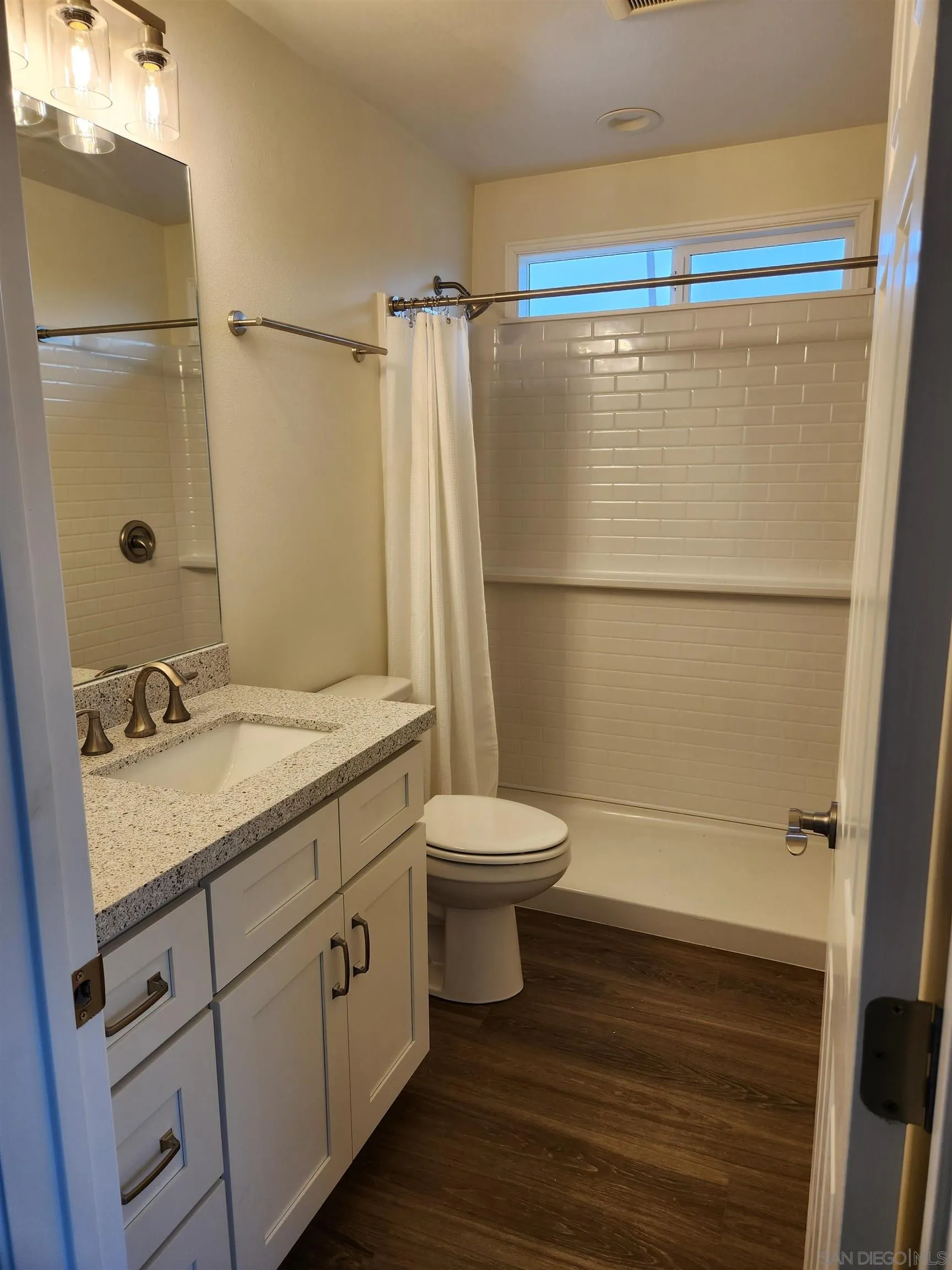 750 North Citrus Avenue, Unit 1 Vista, CA 92084 - Photo 9 of 14 a bathroom with a granite countertop sink toilet and shower