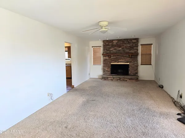 a view of empty room with fireplace