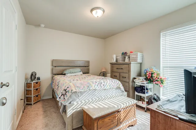a bedroom with a bed and a dresser