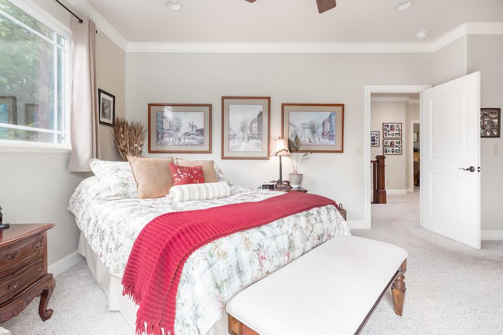 105 E Road Boulder Creek, CA 95006 - Photo 19 of 50 a bedroom with a large bed and a chandelier