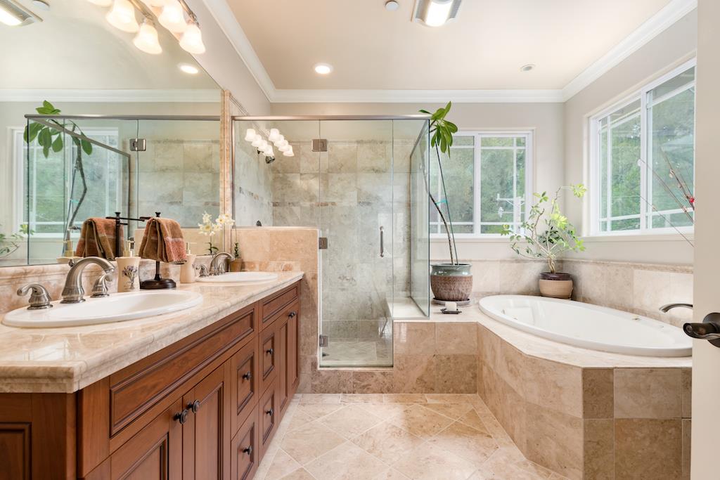 105 E Road Boulder Creek, CA 95006 - Photo 21 of 50 a spacious bathroom with a granite countertop tub sink a mirror a shower and vanity