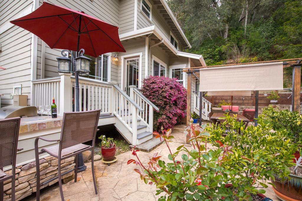 105 E Road Boulder Creek, CA 95006 - Photo 32 of 50 a view of a chair and tables in the backyard of the house