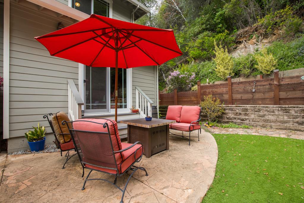 105 E Road Boulder Creek, CA 95006 - Photo 34 of 50 a patio with a table and chairs under an umbrella