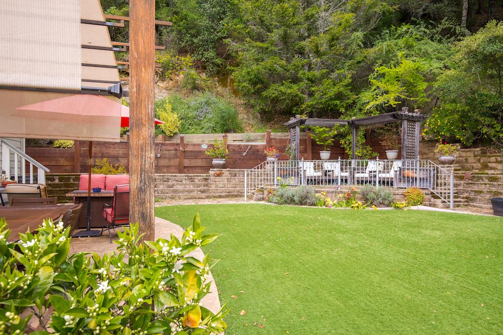 105 E Road Boulder Creek, CA 95006 - Photo 38 of 50 a view of a patio with table and chairs potted plants and large tree