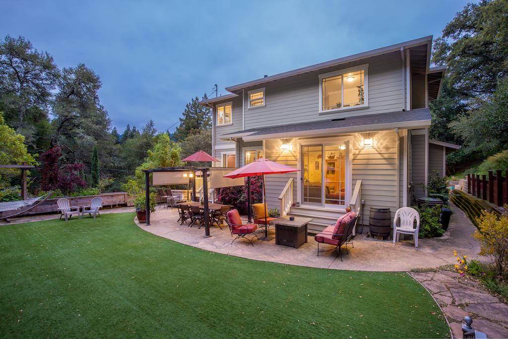 105 E Road Boulder Creek, CA 95006 - Photo 49 of 50 a view of a backyard with table and chairs potted plants and a palm tree