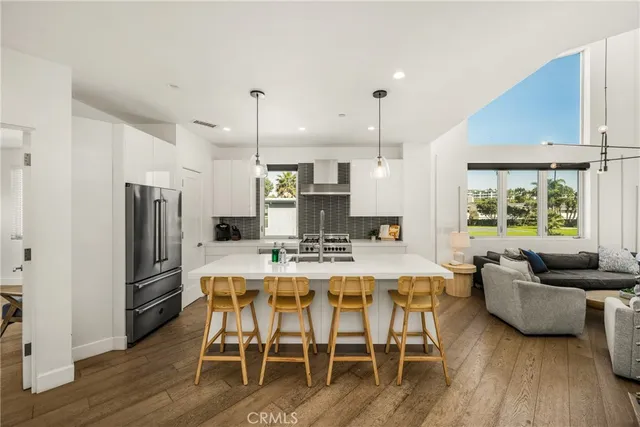 a living room with furniture a flat screen tv and a large window