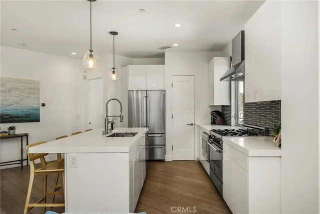 a view of kitchen with sink and wooden floor