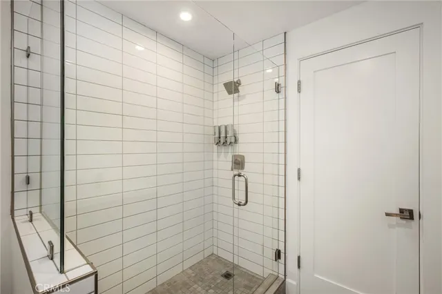 a kitchen with stainless steel appliances granite countertop a sink a stove a refrigerator white cabinets and chairs