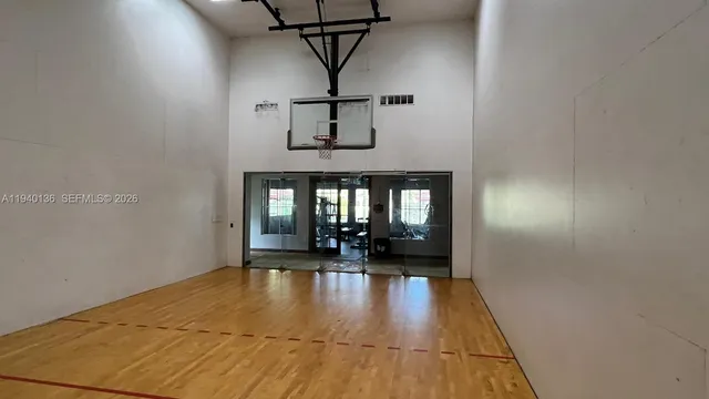 a gym room with gym equipment and a large window