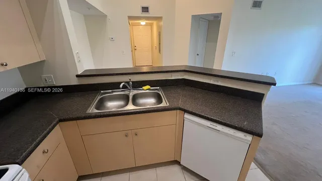 a kitchen with a sink and cabinets