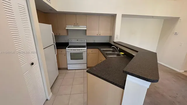 a kitchen with a stove a refrigerator a sink and dishwasher