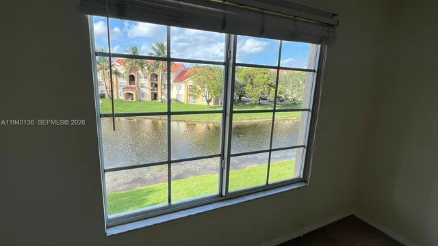 a view of a room has large windows