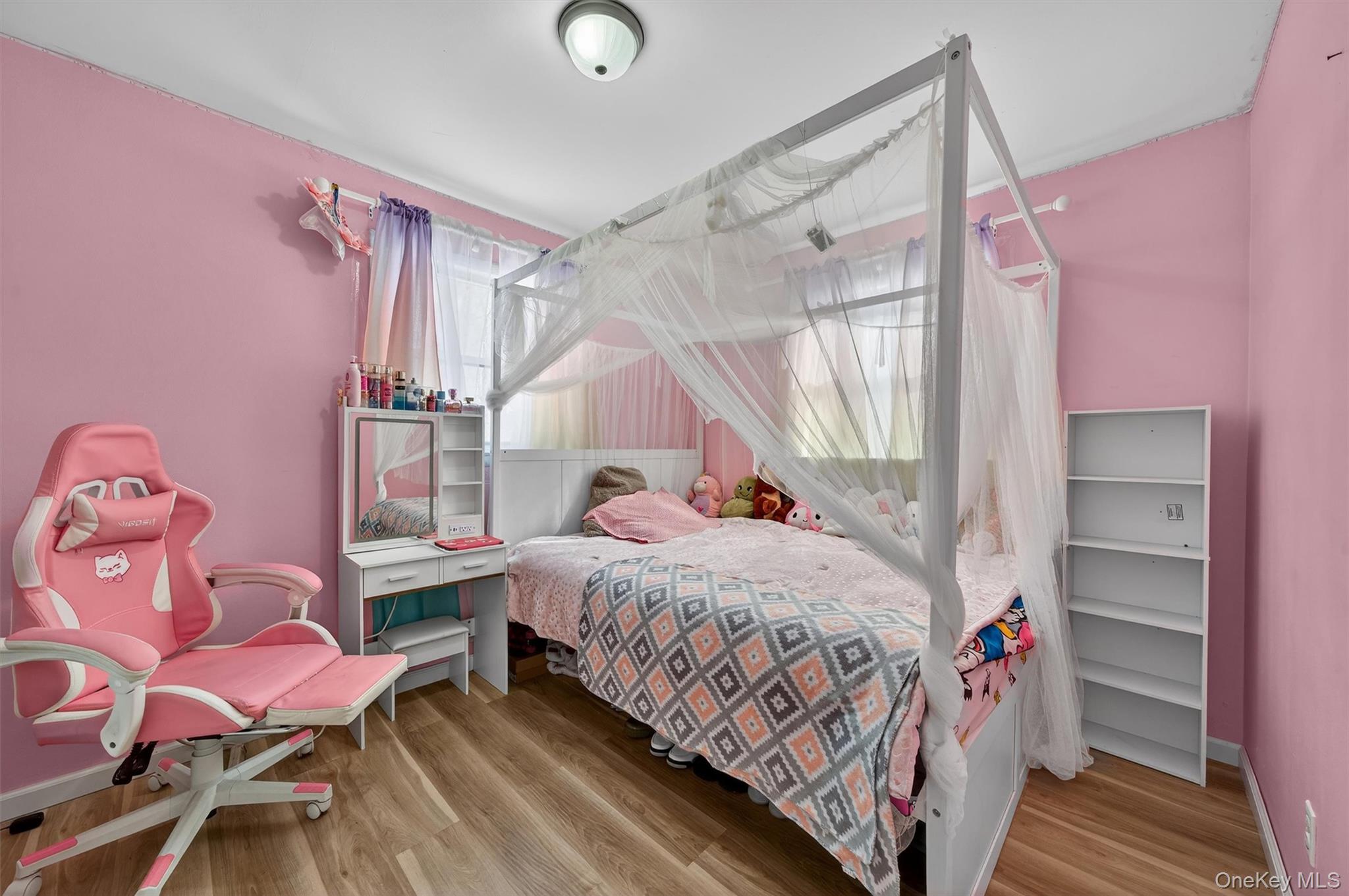 51 East Green Road Rock Tavern, NY 12575 - Photo 22 of 43 a bedroom with a bed and a chandelier