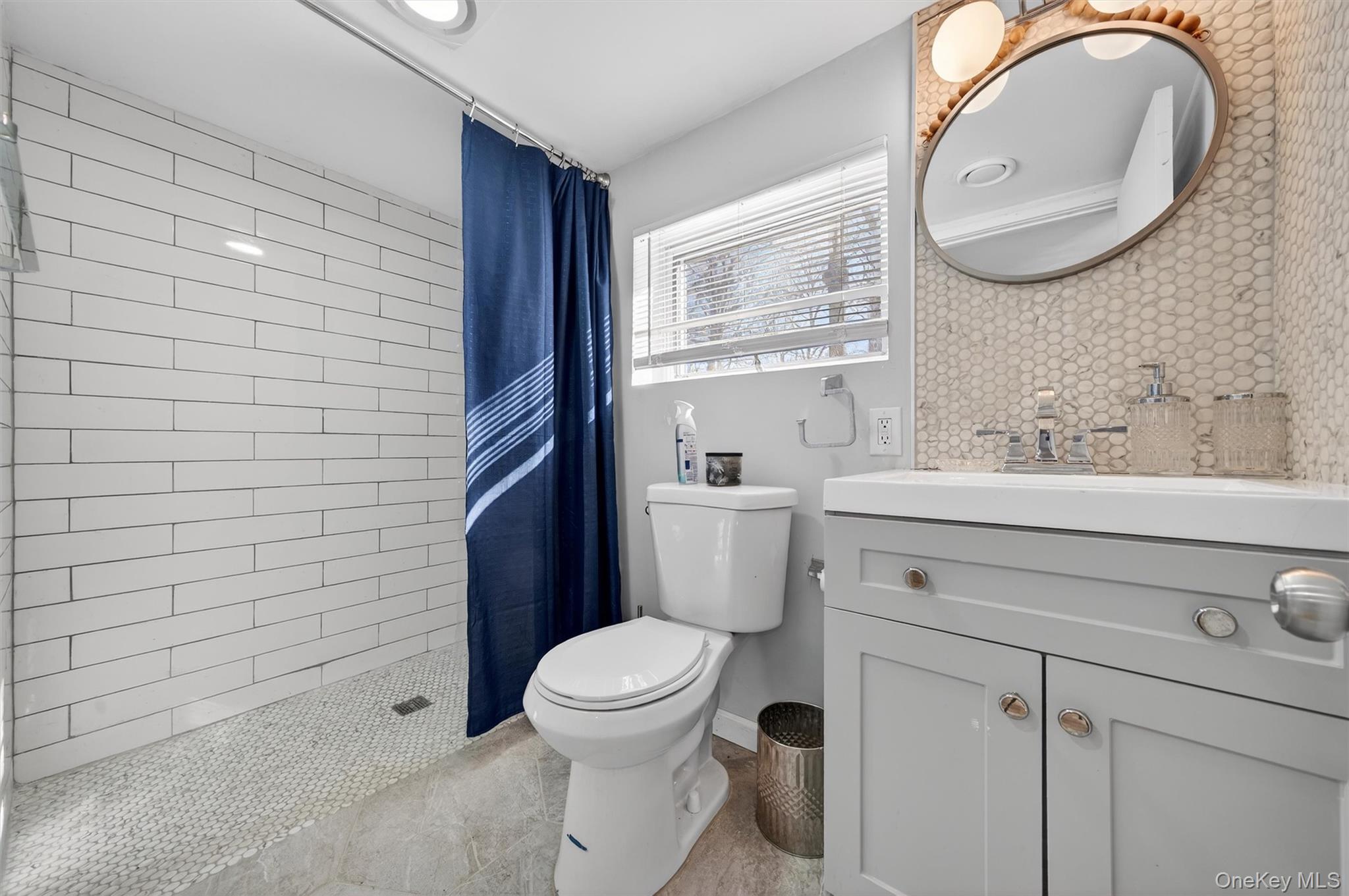51 East Green Road Rock Tavern, NY 12575 - Photo 28 of 43 a bathroom with a toilet sink vanity and mirror