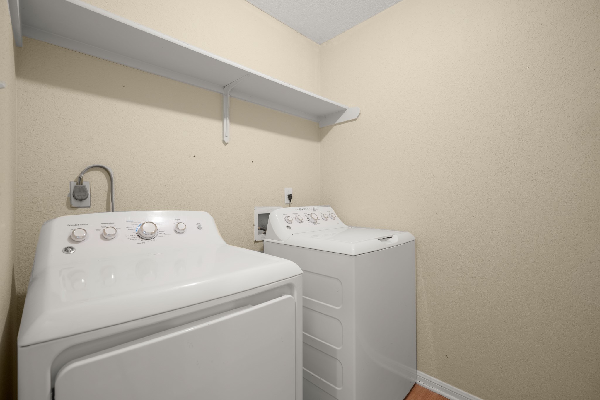 438 Katy Crossing Georgetown, TX 78626 - Photo 20 of 24 A well-appointed utility room features a convenient washer and dryer, complemented by overhead shelving.