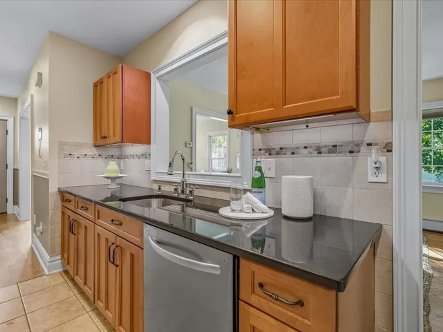a kitchen with stainless steel appliances granite countertop a sink stove and cabinets