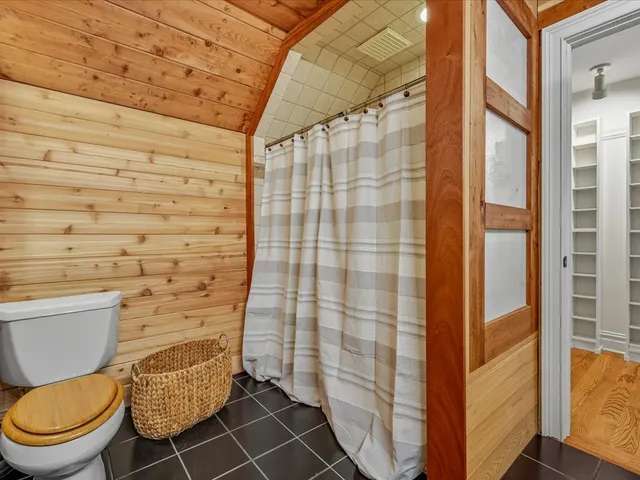 a bathroom with a toilet and a shower