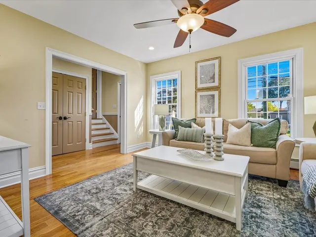 a living room with furniture and wooden floor