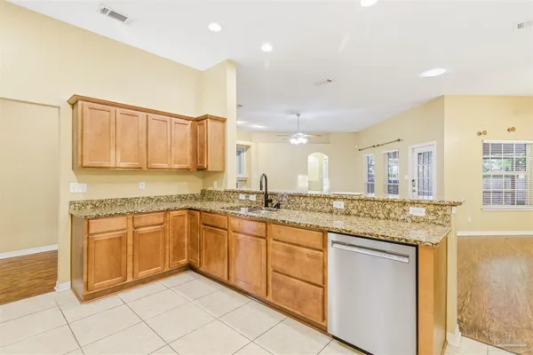 a kitchen with granite countertop cabinets sink and stove
