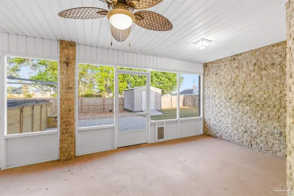 an empty room with a fireplace and large window