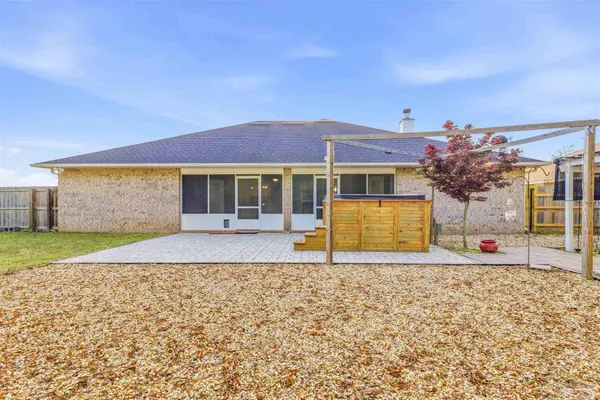 a front view of a house with a garden and yard
