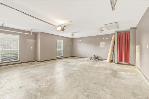 an empty room with windows and closet