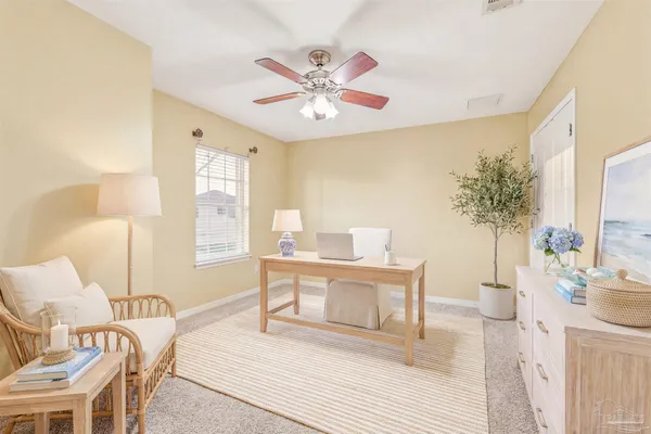a living room with furniture a chandelier and a window