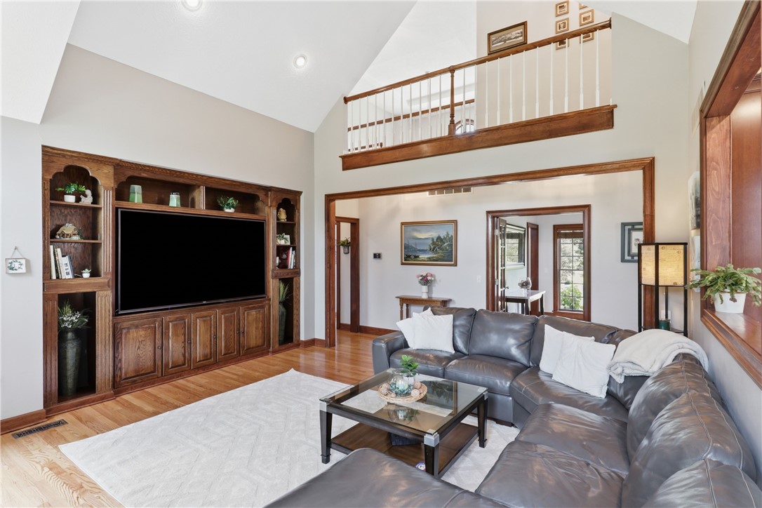 2057 Stirnie Road Victor, NY 14564 - Photo 8 of 48 Another view of the expansive living room, showcasing its connection to the rest of the main floor. The warm neutral palette, plush carpeting, and generous layout offer an ideal configuration for effortless daily living.