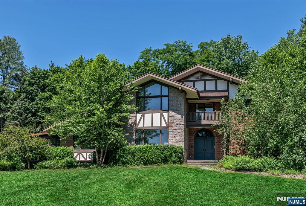 681 Closter Dock Road Closter, NJ 07624 - Photo 1 of 40 a front view of a house with a yard and trees