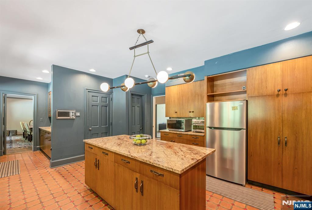 681 Closter Dock Road Closter, NJ 07624 - Photo 11 of 40 a kitchen with stainless steel appliances granite countertop a sink a refrigerator and a wooden floor