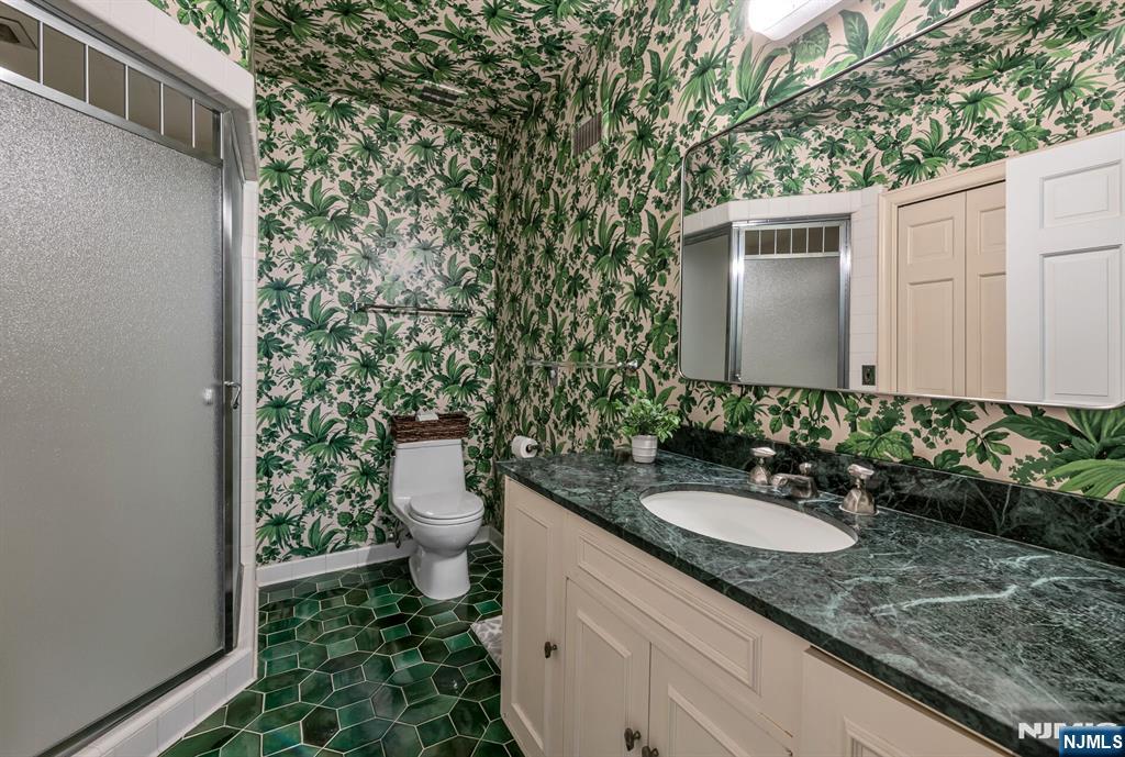 681 Closter Dock Road Closter, NJ 07624 - Photo 26 of 40 a bathroom with a sink and mirror with toilet