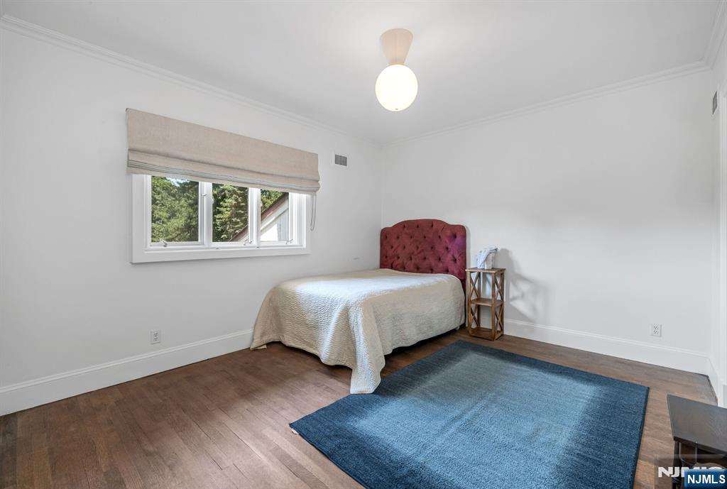 681 Closter Dock Road Closter, NJ 07624 - Photo 29 of 40 a bed sitting in a bedroom next to a window