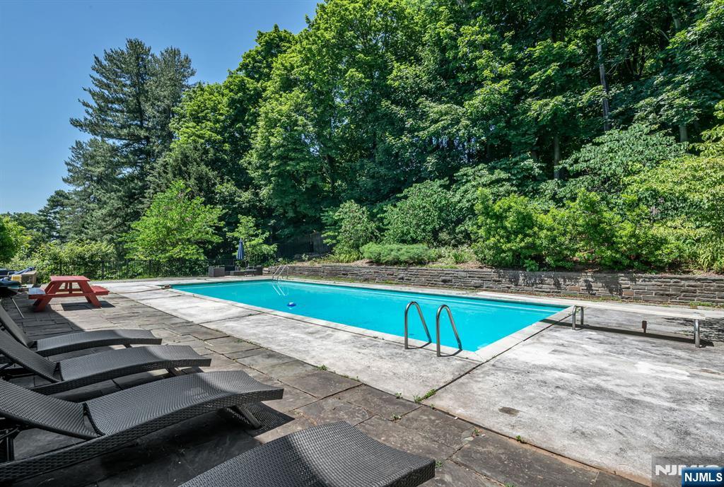 681 Closter Dock Road Closter, NJ 07624 - Photo 32 of 40 a view of a swimming pool with a patio