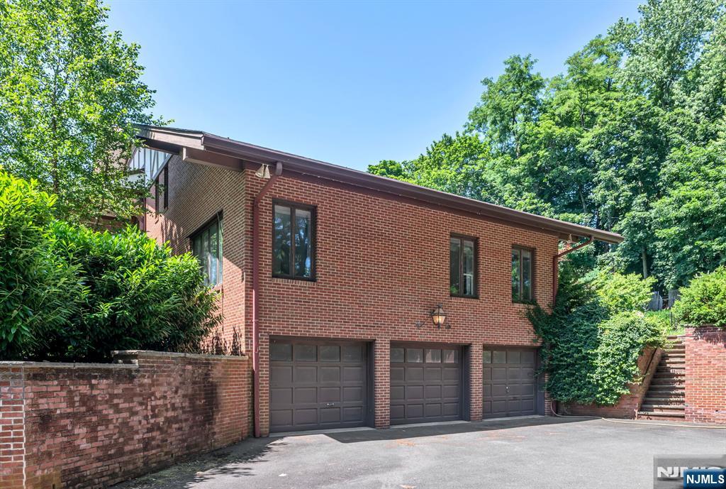 681 Closter Dock Road Closter, NJ 07624 - Photo 34 of 40 a front view of a house with a garden