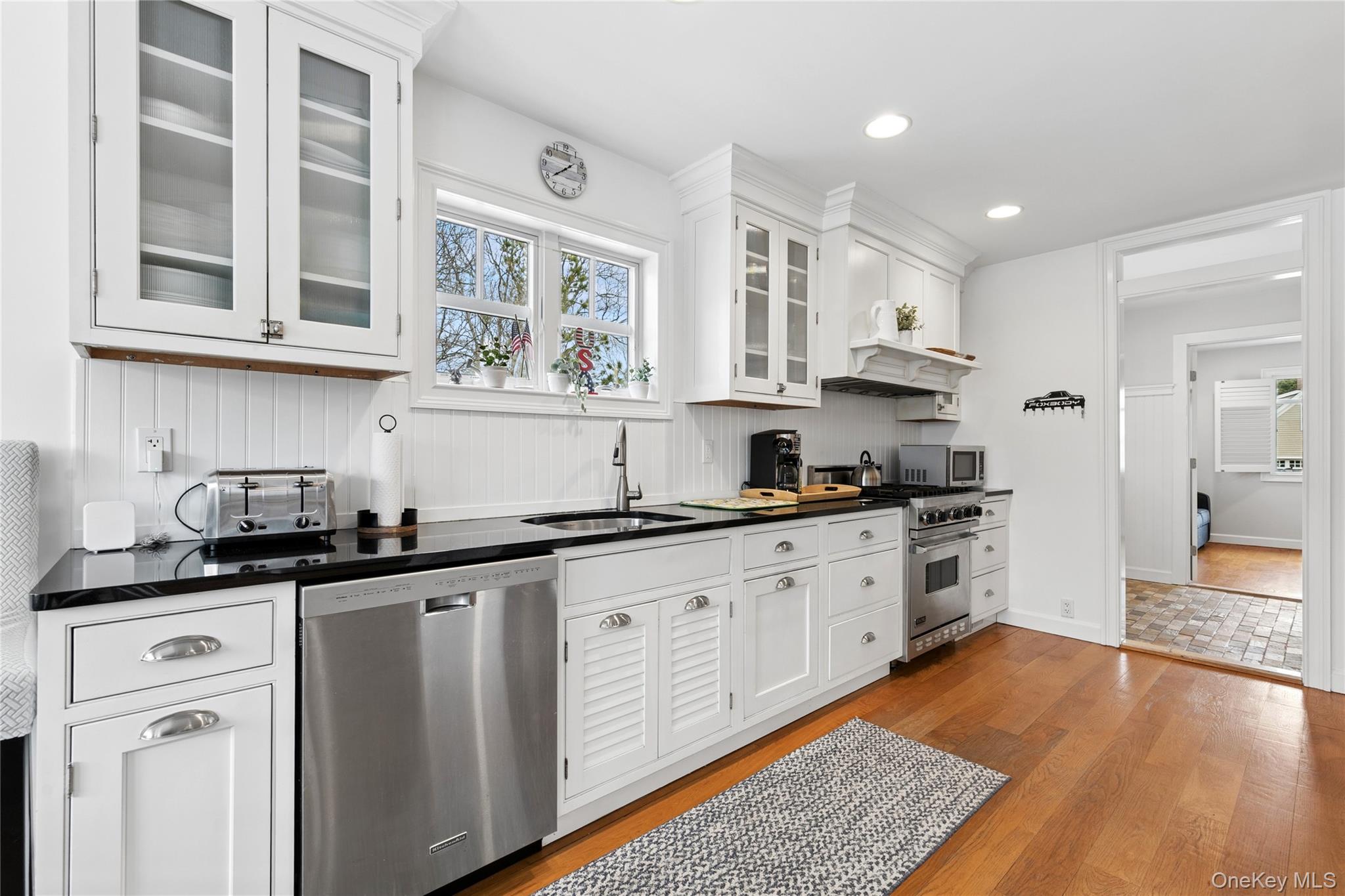 10 Foxboro Road East Quogue, NY 11946 - Photo 11 of 31 a kitchen with granite countertop a sink and cabinets
