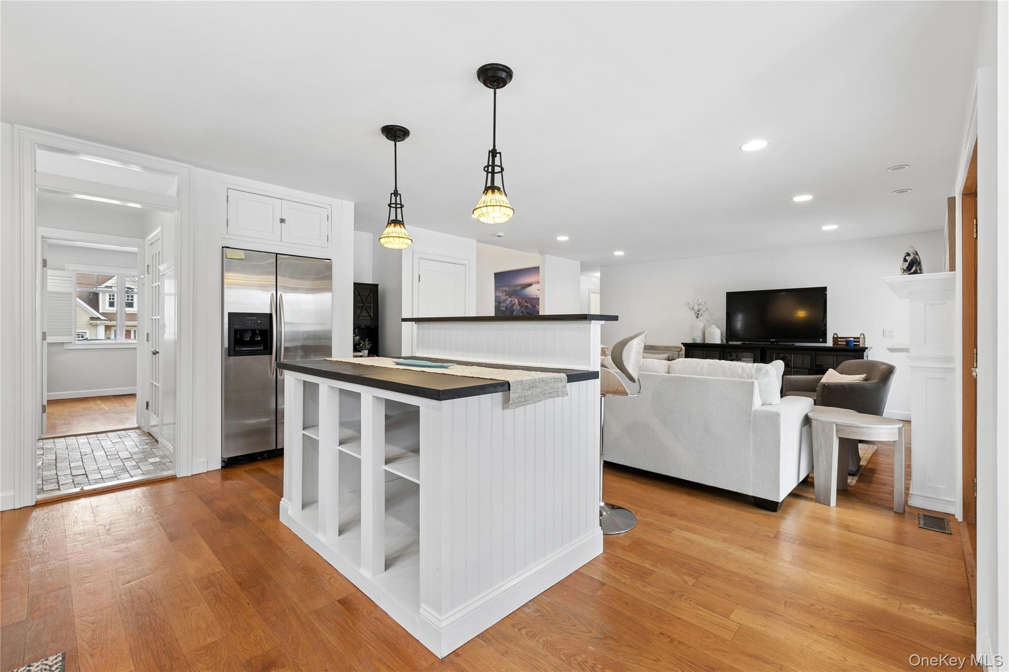 10 Foxboro Road East Quogue, NY 11946 - Photo 14 of 31 a kitchen with white cabinets and stainless steel appliances