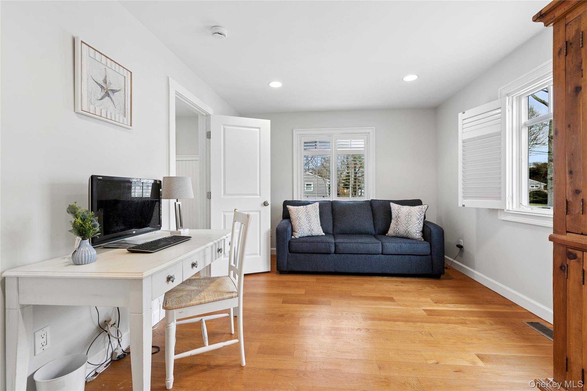 10 Foxboro Road East Quogue, NY 11946 - Photo 18 of 31 a living room with furniture and a flat screen tv