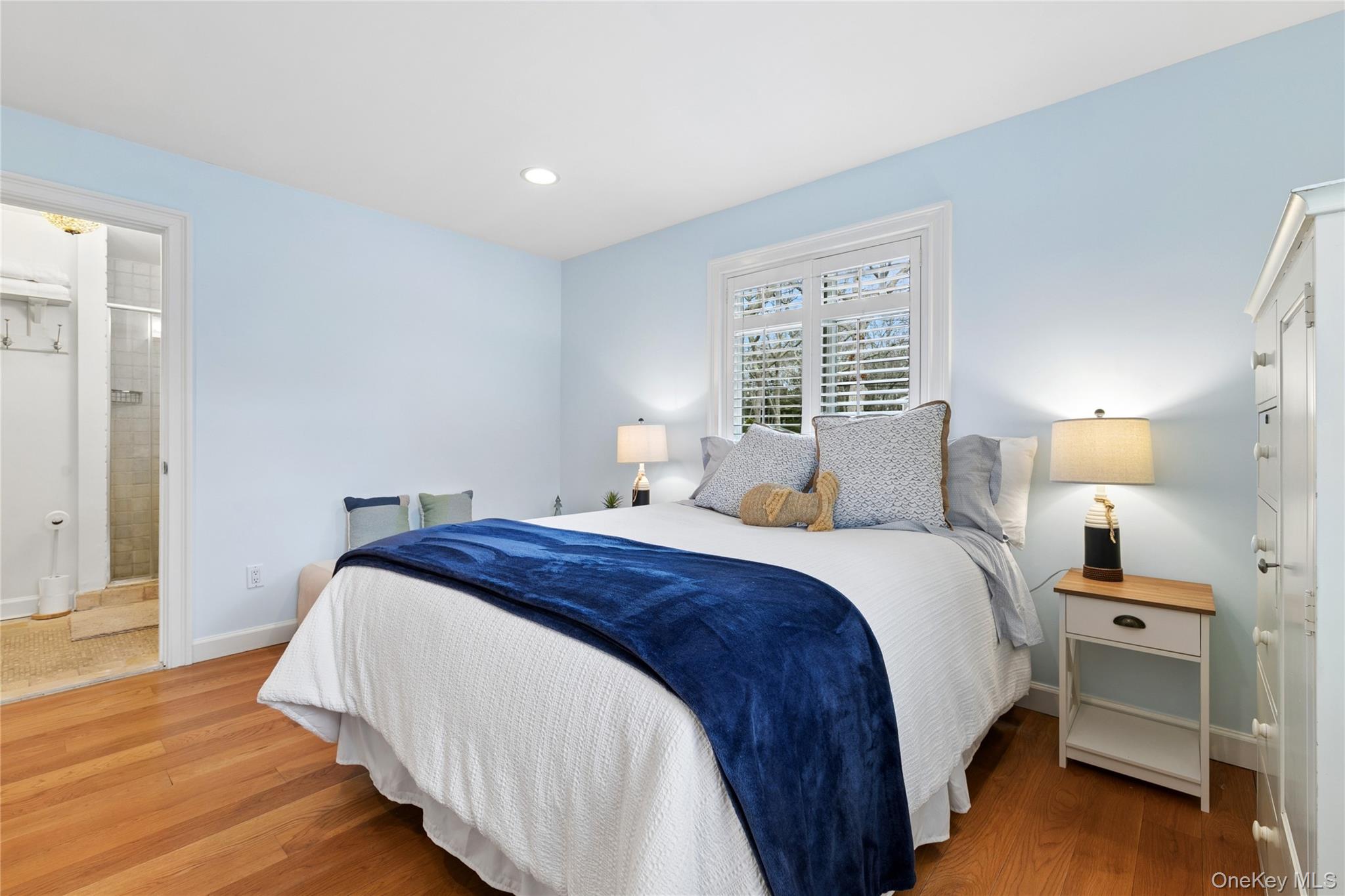10 Foxboro Road East Quogue, NY 11946 - Photo 22 of 31 a bedroom with a bed and a lamp