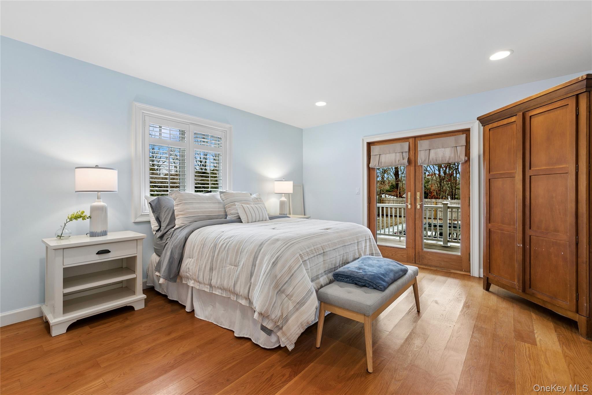 10 Foxboro Road East Quogue, NY 11946 - Photo 24 of 31 a spacious bedroom with a bed and a dresser next to a window