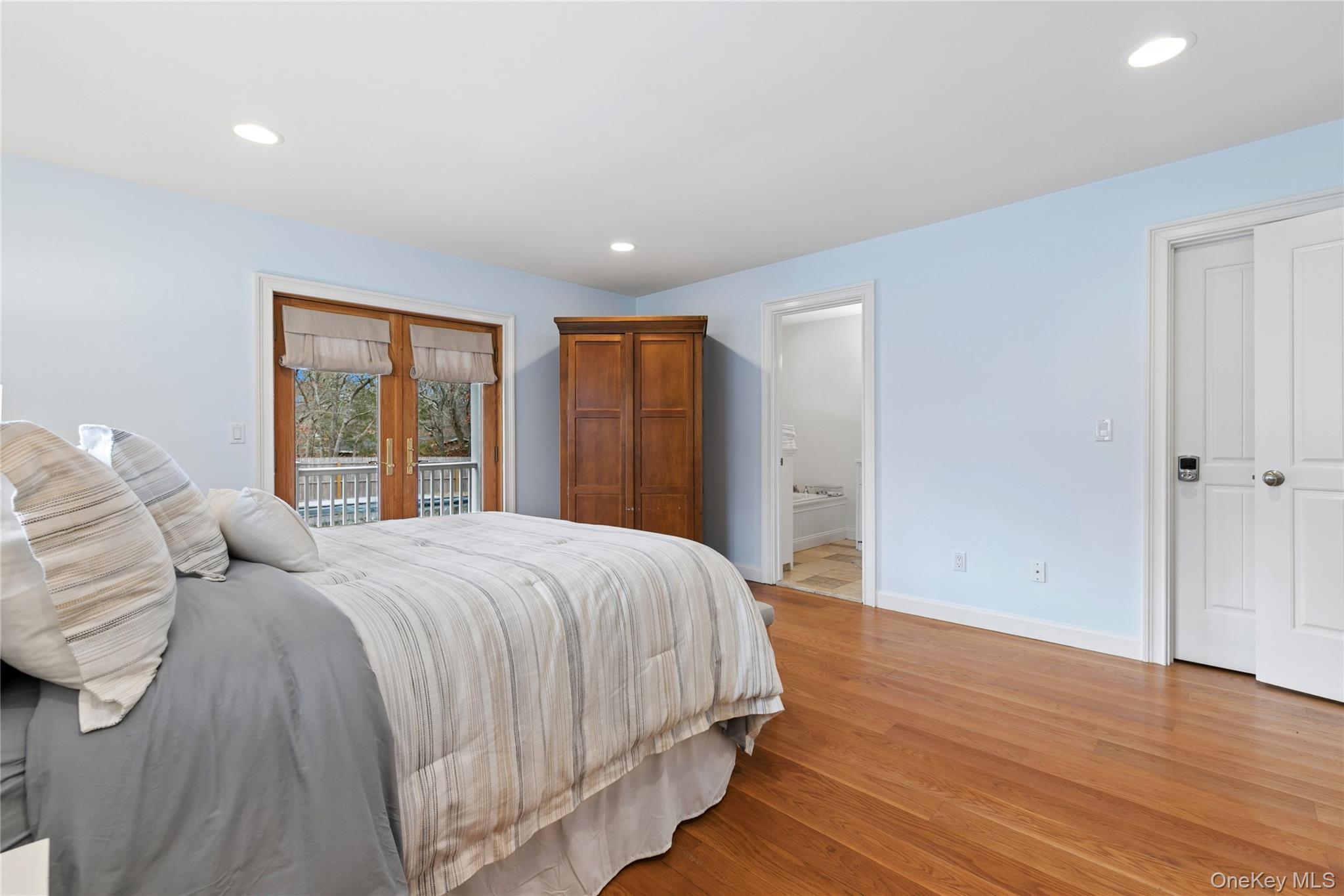 10 Foxboro Road East Quogue, NY 11946 - Photo 25 of 31 a bedroom with a large bed closet and wooden floor