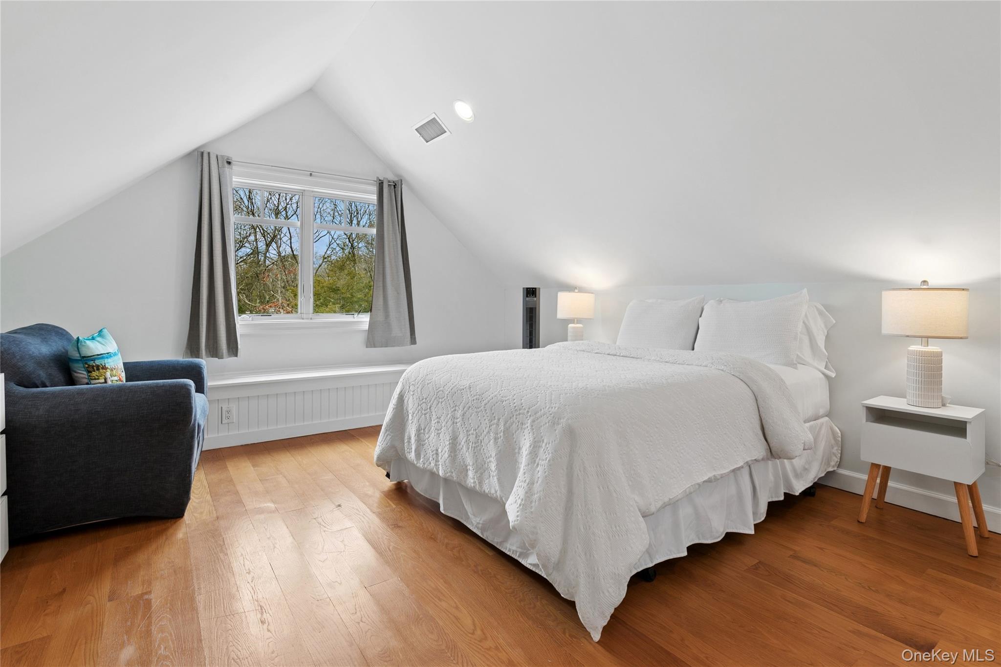 10 Foxboro Road East Quogue, NY 11946 - Photo 28 of 31 a spacious bedroom with a bed and a couch